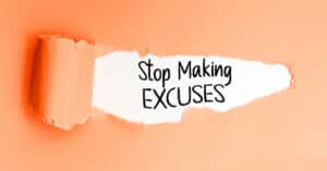 Stop Making Excuses Phrase under torn paper for motivation