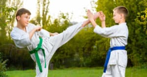 Young Boys in White Kimono Practicing Fighting Techniques Outdoors Near Raliegh NC
